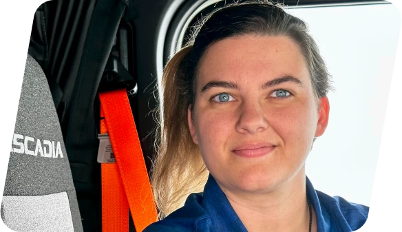 A CDL-A driver in a Freightliner Cascadia truck, representing job opportunities in North and South Carolina