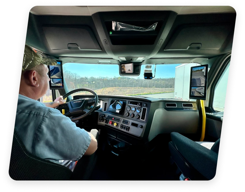 Truck interior from a dedicated trucking company near Charlotte NC, showing the driver and advanced dashboard controls.