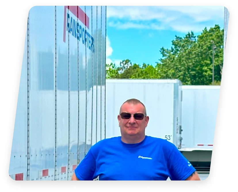 Person standing in front of a Logistic Trucking Company's semi-trailer truck in Battleboro, NC.