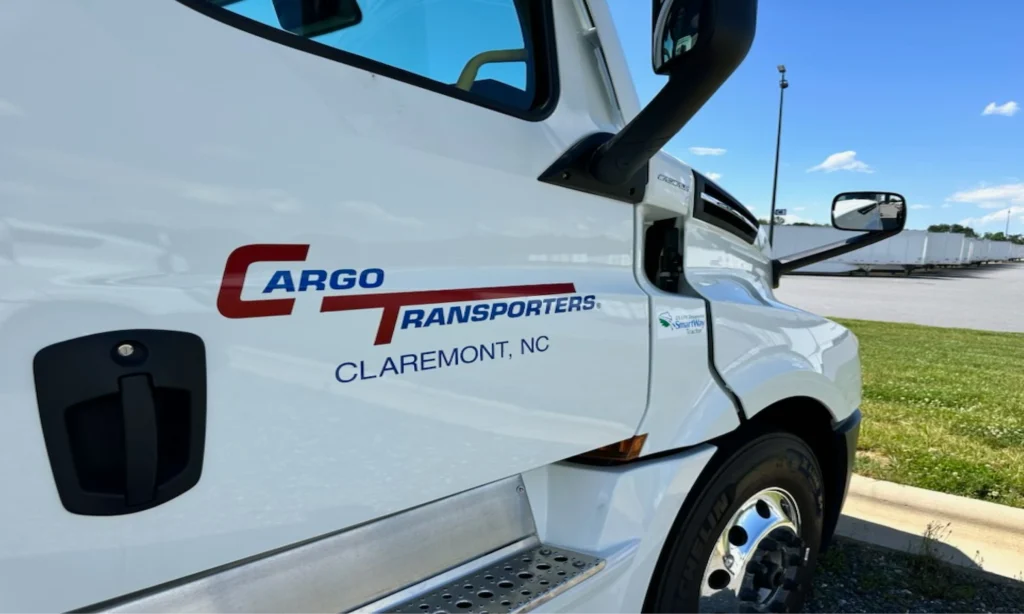 Cargo Transporters truck showcasing the company's logo and location in Claremont, NC, representing a leading trucking and logistics company.