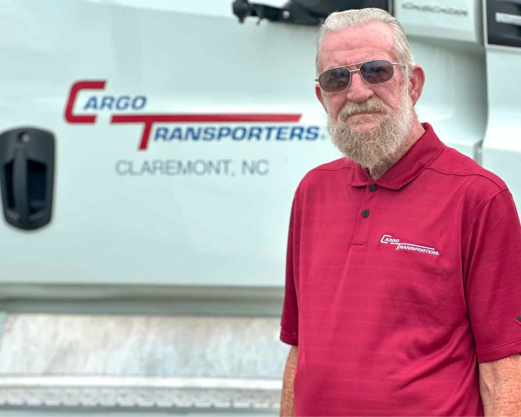 Larry Leatherman, October Driver of the Month, standing in front of a Cargo Transporters truck in Claremont, NC.