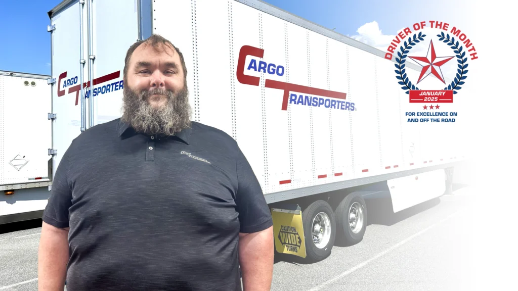 Greg Harrison, Driver of the Month for January 2025, stands in front of a Cargo Transporters trailer, highlighting CDL A driving jobs near Charlotte NC.