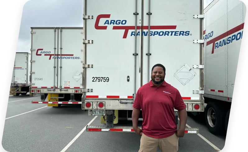 Cargo Transporters employee stands in front of freight carrier trailers supporting transportation services on East Coast
