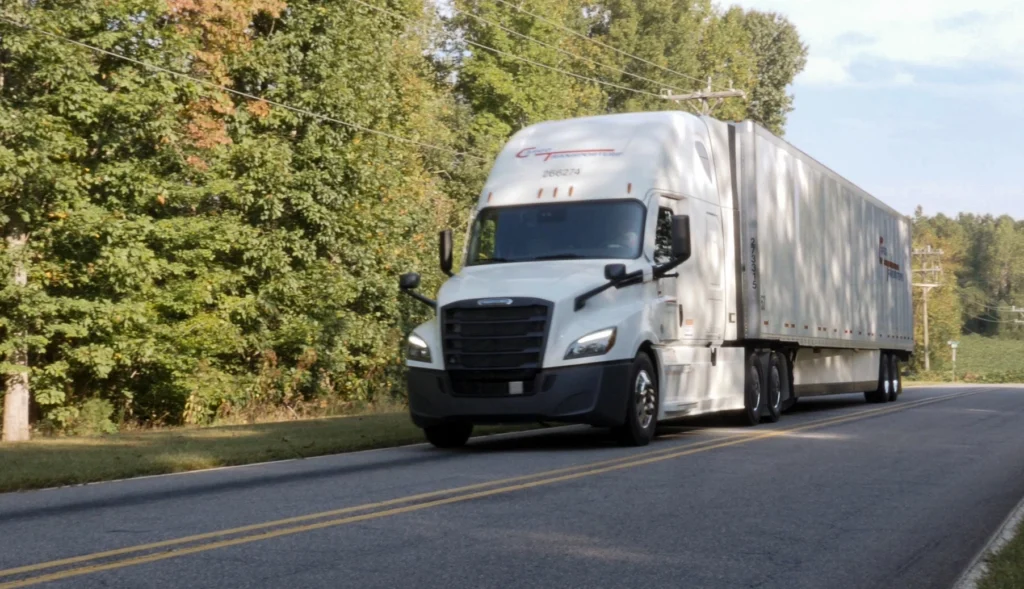 Cargo Transporters truck on highway representing OTR driver pay increase